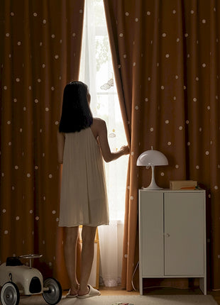 a woman standing in front of a window next to a toy car