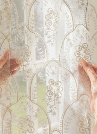 a pair of hands holding a window curtain