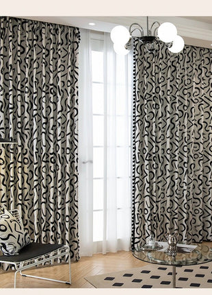 a living room with a black and white patterned curtain