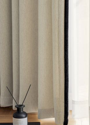 a black and white vase sitting on top of a wooden floor