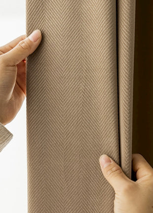 a person holding a curtain with their hand