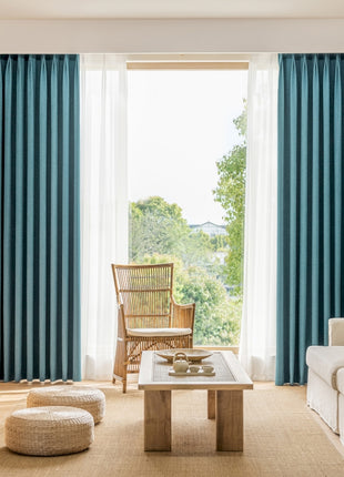 a living room filled with furniture and a large window