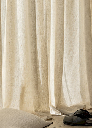 a pair of black shoes sitting on top of a bed