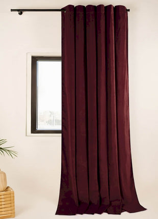 a room with a window and a potted plant