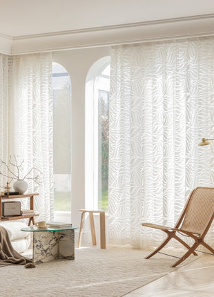 a living room filled with furniture and a large window