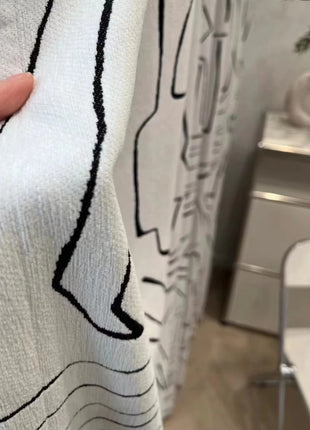 a person is holding a shower curtain in a bathroom