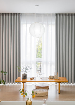 a living room filled with furniture and a large window