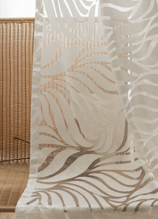 a wooden chair sitting next to a white curtain