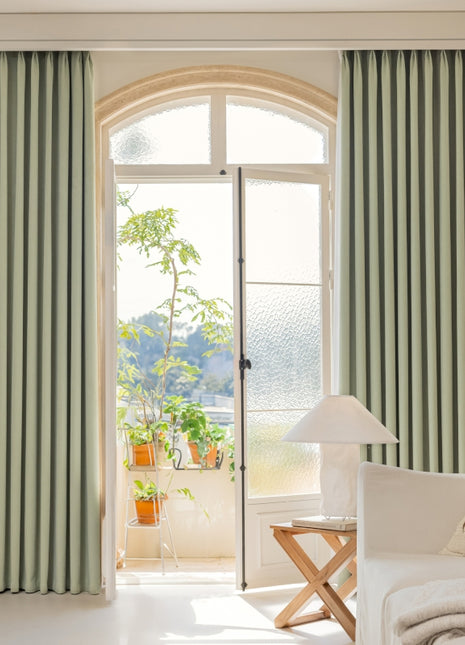 a living room filled with furniture and a large window