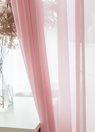 a vase of flowers sitting on a table next to a window