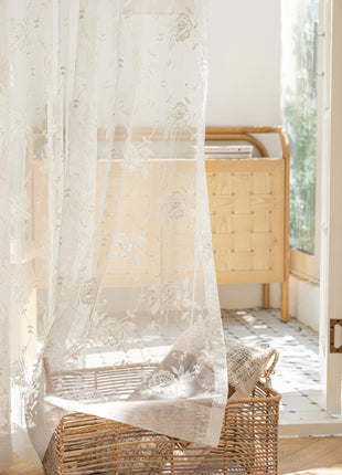 a bedroom with a bed and a basket on the floor