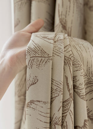 a person holding a curtain with their hand