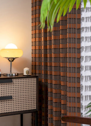 a living room with a lamp and a dresser