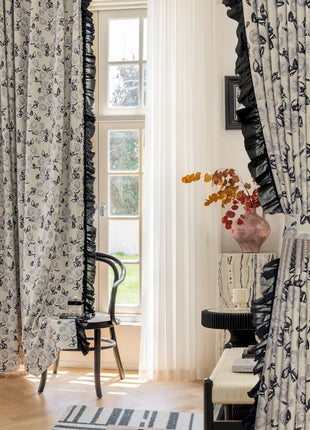 a living room with a chair and a window