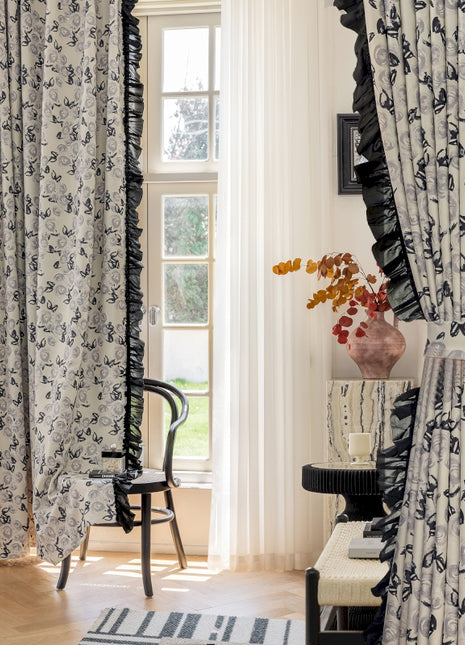a living room with a chair and a window