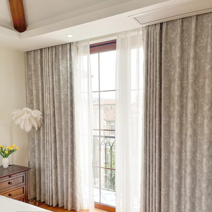 a bedroom with a bed and a window with curtains