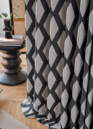 a living room with a black and white patterned curtain