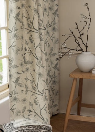 a white vase sitting on top of a table next to a window