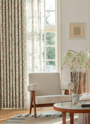 a living room filled with furniture and a window covered in curtains