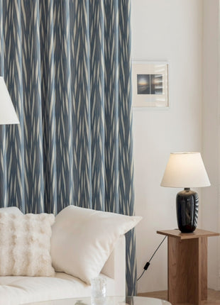 a living room with a white couch and a lamp