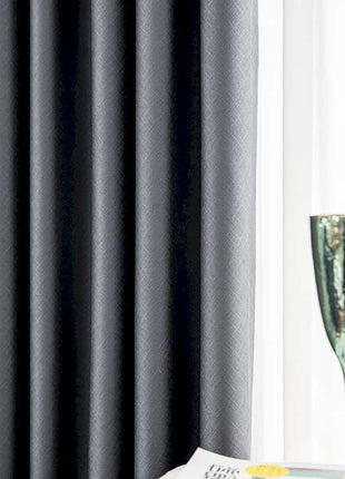 a glass of wine and a book on a table