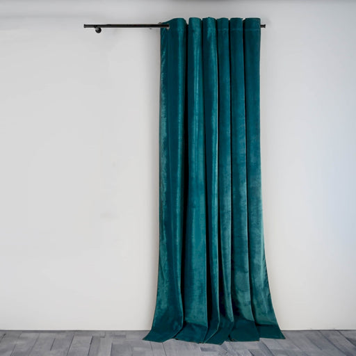 a green curtain hanging on a white wall
