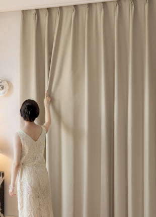 a woman in a wedding dress looking out a window