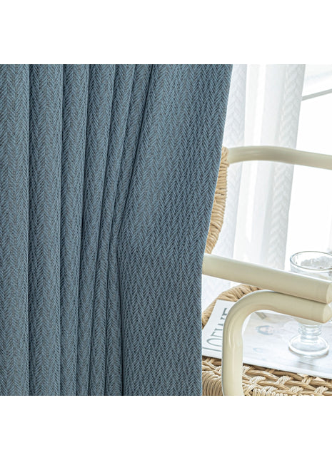a close up of a curtain with a chair in the background