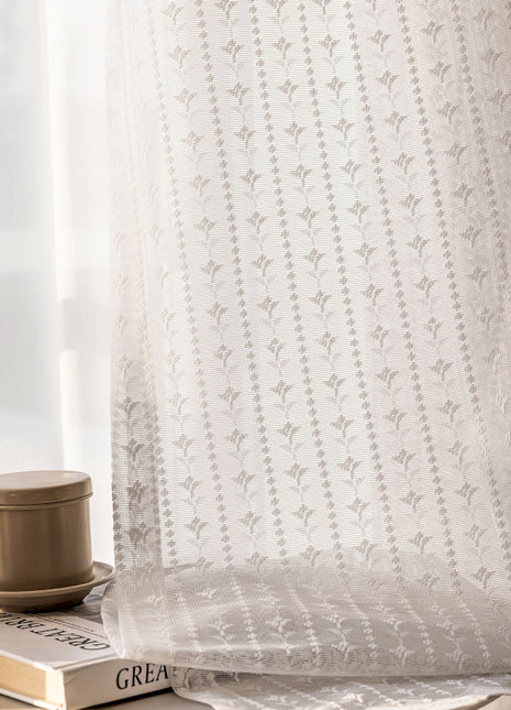 a coffee cup sitting on top of a book next to a window