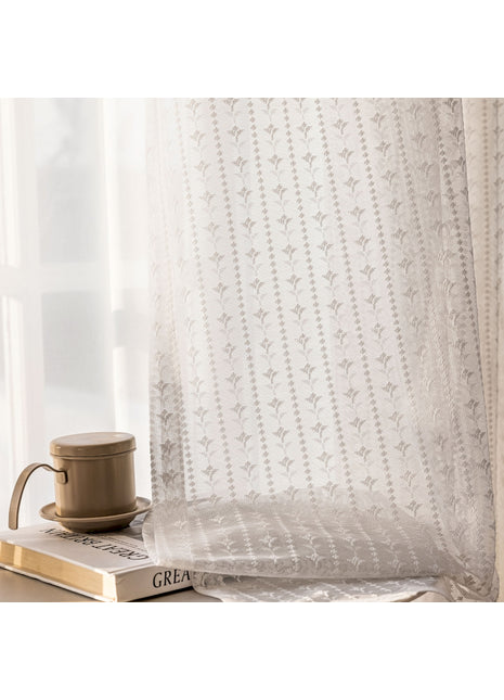 a coffee cup sitting on top of a book next to a window