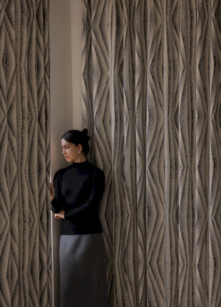 a woman leaning against a wall with her hands on her hips