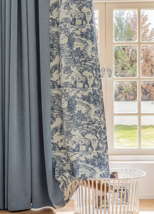 a window with a curtain and a basket in front of it