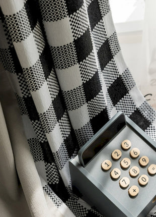 a black and white checkered curtain with buttons on it