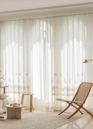 a living room with a white couch and a chair