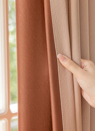a person's hand on a curtain with a window in the background