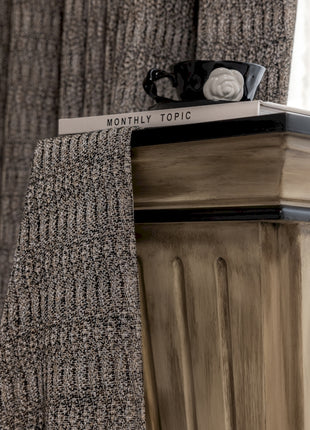 a close up of a tie on top of a dresser