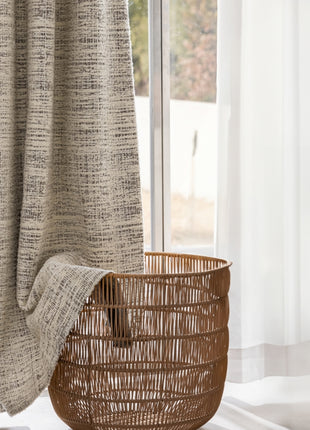 a wicker basket sitting in front of a window
