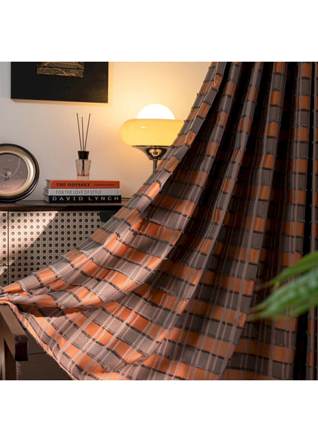 a room with a bed, a lamp, a clock and a curtain