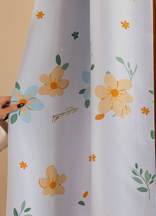 a woman is opening a curtain with a pair of scissors