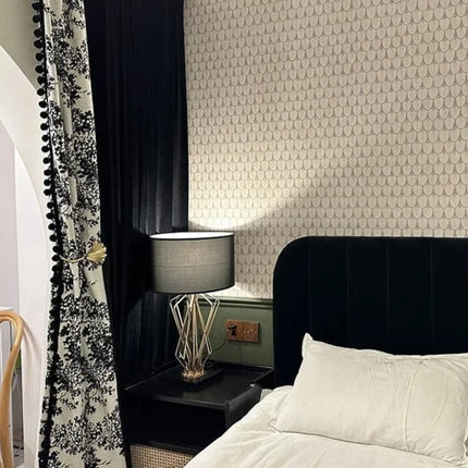 a bedroom with a black headboard and a white bed