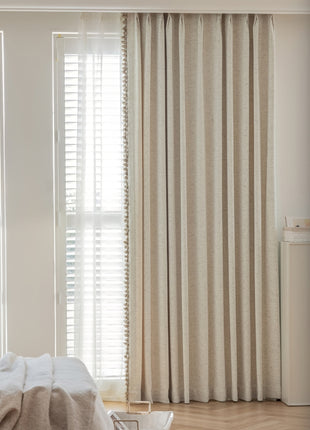 a bedroom with a bed and a window with white blinds