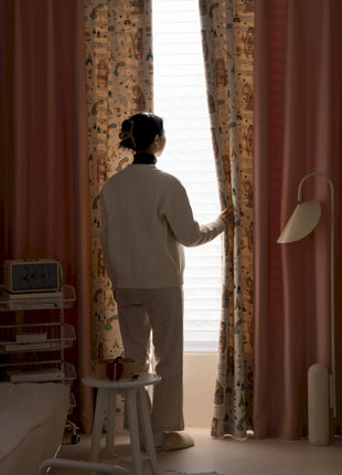 a woman standing in front of a window