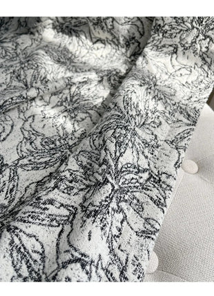 a close up of a white and black blanket