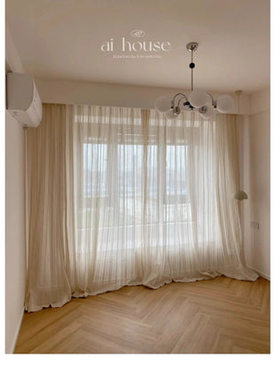 a living room with a large window and a wooden floor