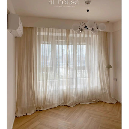 a living room with a large window and a wooden floor