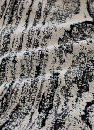 a close up of a black and white rug