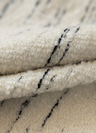 a close up of a white rug with black lines