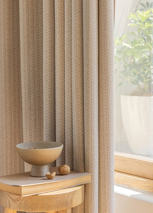 a bowl on a table in front of a window