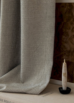 a white candle sitting on top of a book