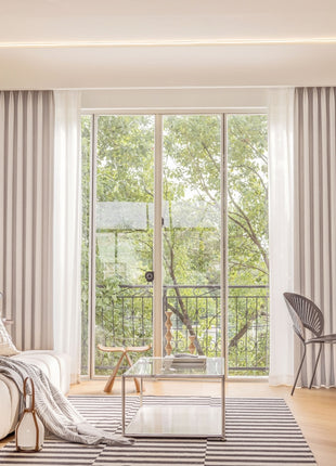 a living room filled with furniture and a sliding glass door